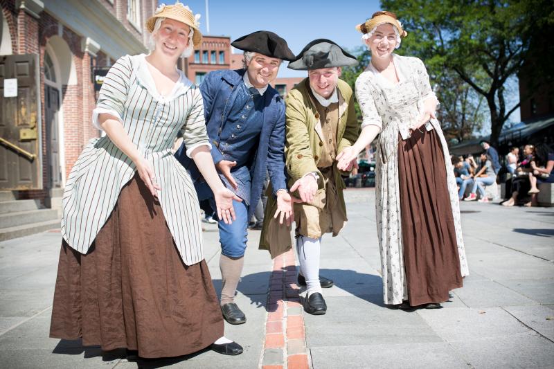 Freedom Trail Players® pointing to the Trail at Faneuil Hall